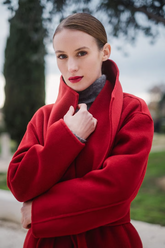 a lady in a red woolen coat